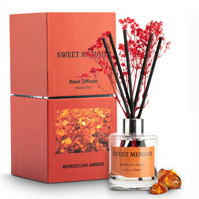 Vibrant orange Sweet Memoir Moroccan Amber Reed Diffuser 150ml with amber crystals and red reed sticks.