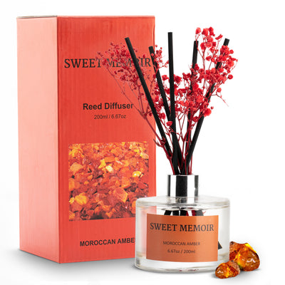 Vibrant orange Sweet Memoir Moroccan Amber Reed Diffuser 200ml with amber crystals and red reed sticks.